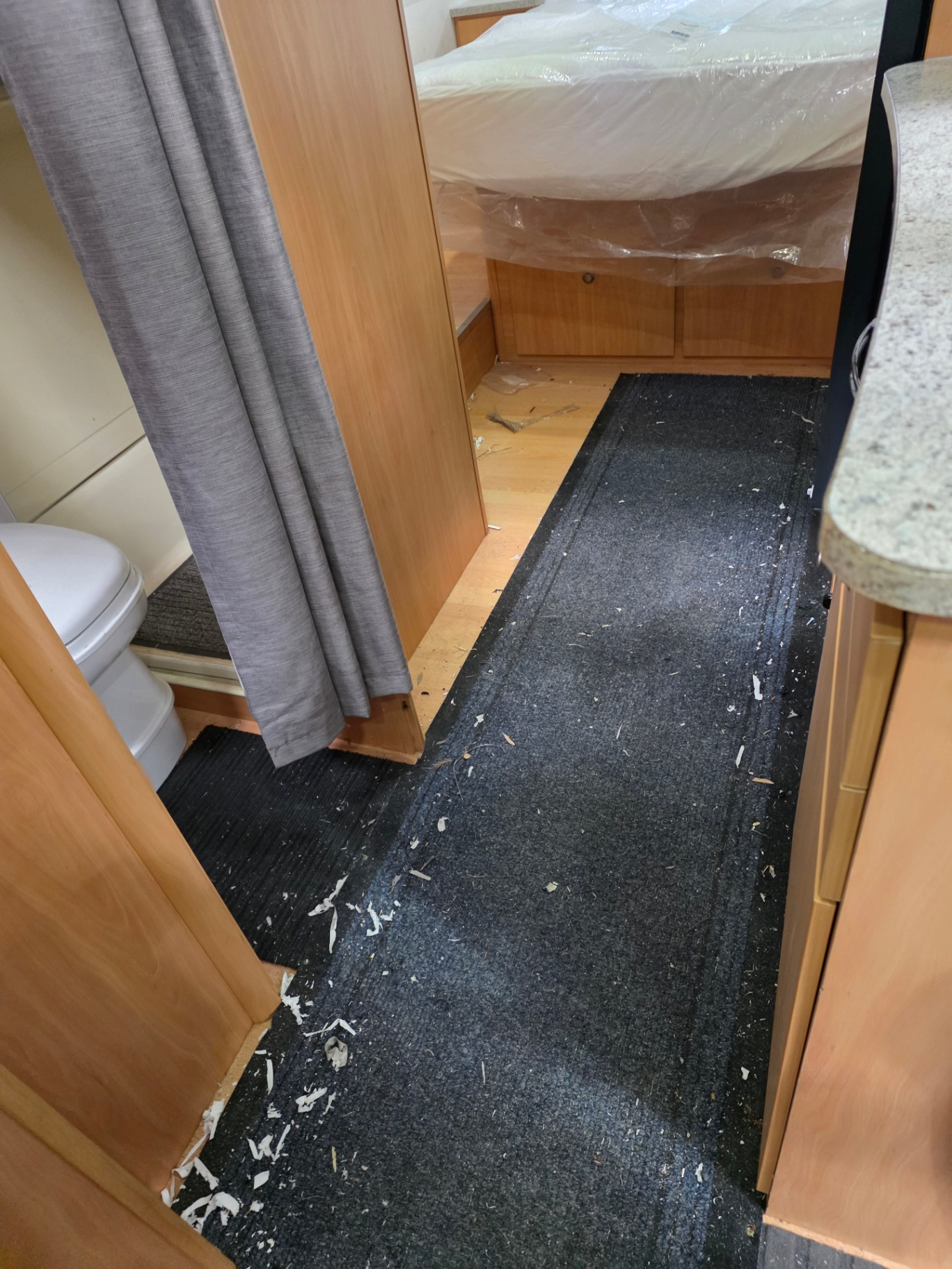 Caravan interior before — dusty floor and debris